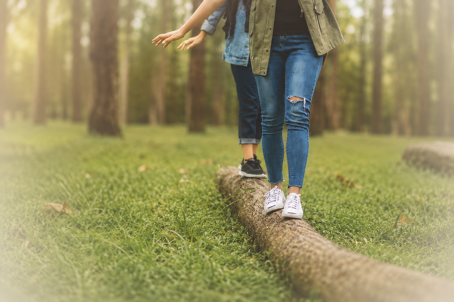 People walking/balancing on a log
